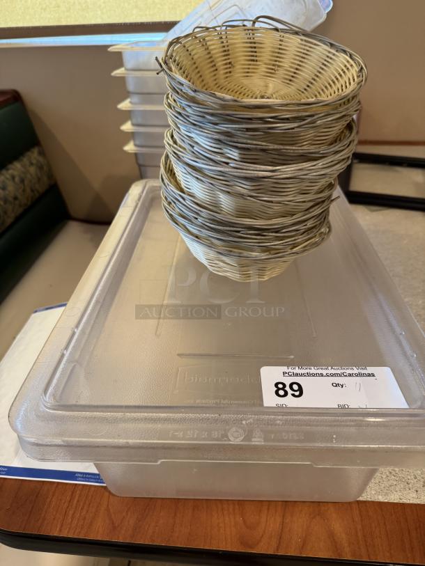 Large acrylic container with lid, includes 10 stackable bread baskets. Slight wear visible. Auction tag with lot number 89.
