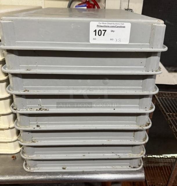 Stack of 8 dough pans in used condition, labeled "107, Qty: 8" for auction. Ideal for bulk baking needs.