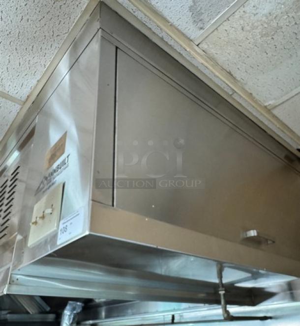 Mannbuilt stainless steel hood in good condition, featuring a sleek design. Visible label indicates model and make.