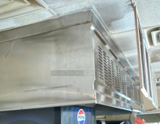 Mannbuilt stainless steel hood, restaurant-grade, with vents, good condition. Ideal for commercial kitchen ventilation.