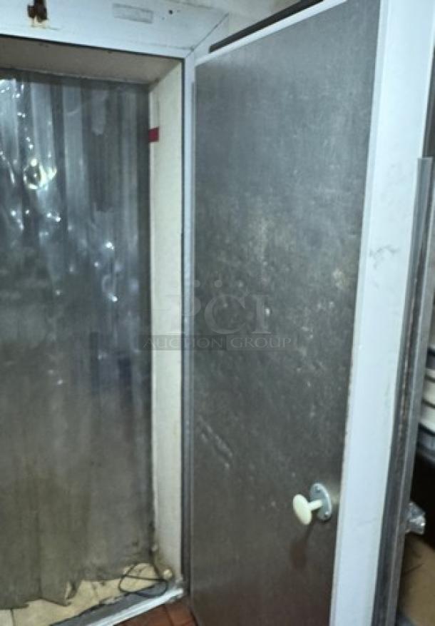 Cooler door with handle, measuring 37" wide and 79.5" high. Metal finish, shows signs of wear. Ideal for refrigeration.