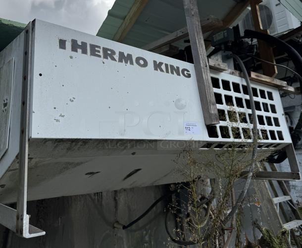 Thermo King box freezer, white, tested and working. Worn exterior with visible branding. Auction label "112" attached.