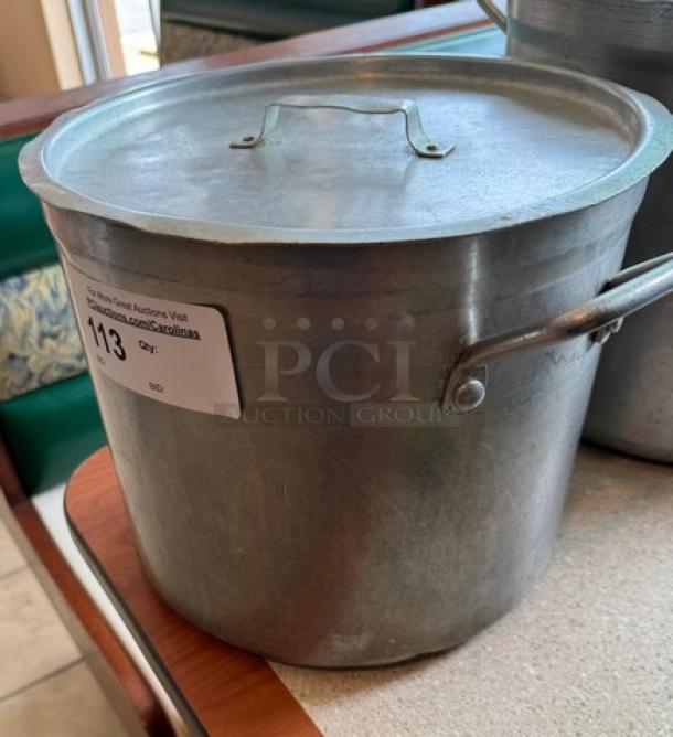 16 Qt. Chef's Stock Pot with lid, metal, used condition, features side handles and auction label numbered 113.