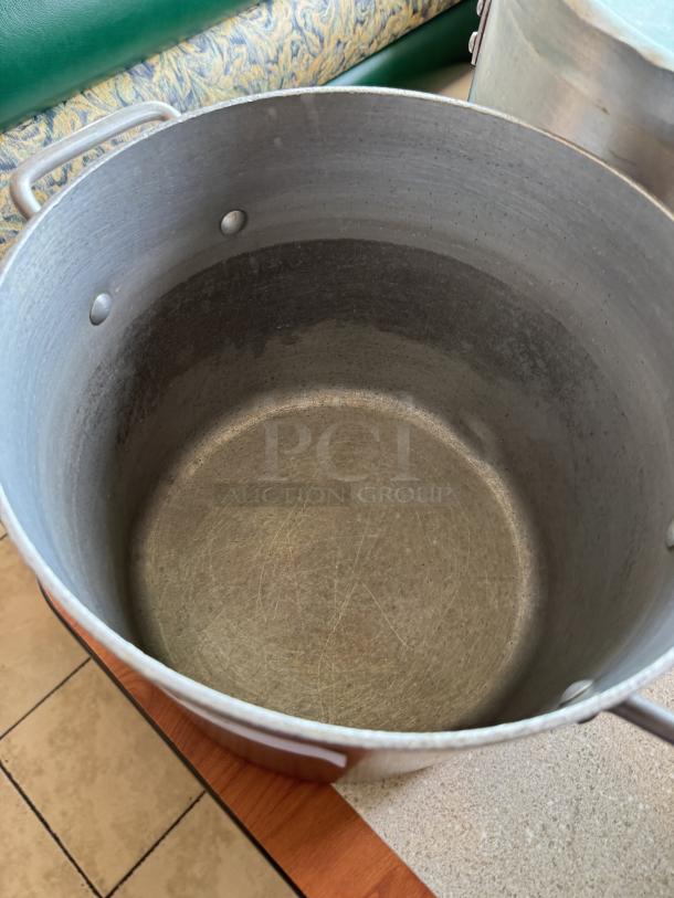 16 Qt. chefs stock pot with lid, aluminum, side handles, signs of use, ideal for large batch cooking.