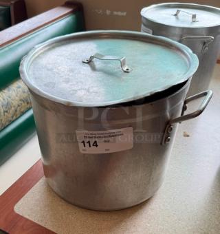 24 Qt. Chefs Stock Pot with Lid, metal finish, side handles, visible wear. Auction tag with lot number 114 attached.