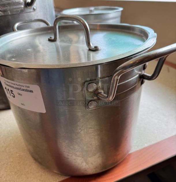 28 Qt. Chefs Stock Pot with Lid, stainless steel, sturdy handles, lightly worn, auction tag visible on side.