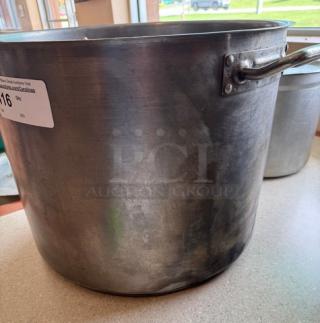 Large 60 Qt. chefs stock pot with side handles, stainless steel, used condition. Auction tag attached. Ideal for commercial cooking.