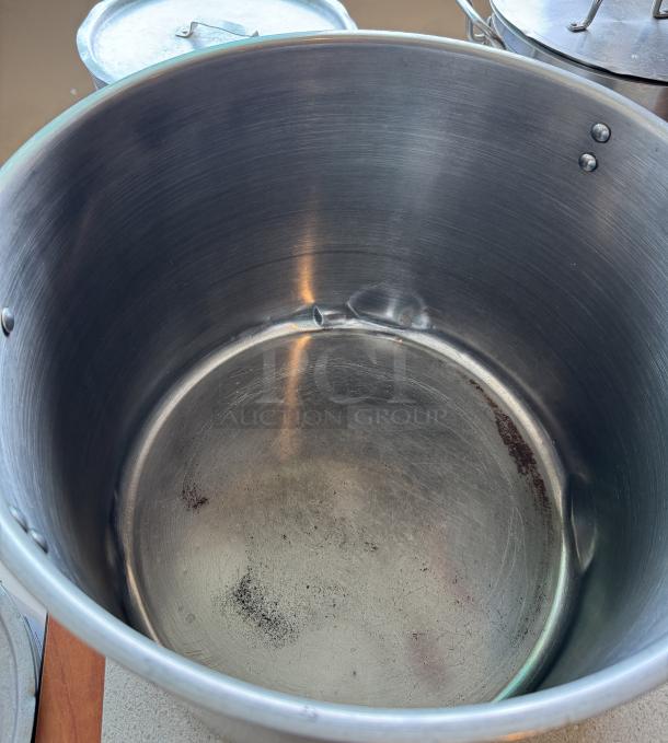 60 Qt. Chefs Stock Pot, stainless steel, interior shows wear and minor dents, no visible brand markings, lid included.