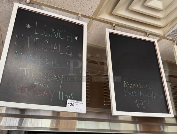 Two hanging chalkboards with white frames displaying colored chalk writing; one details lunch specials. In good condition.