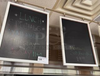 Two hanging chalkboards with white frames displaying colored chalk writing; one details lunch specials. In good condition.