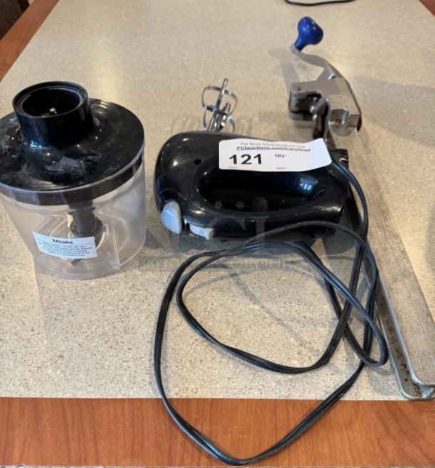 Handheld mixer, chopper, and can opener set, black and chrome finish, includes power cord and clear chopper bowl. Auction tag marked "121."