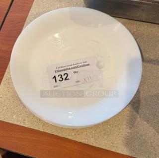 White ceramic dinner plate, 10 inches, in excellent condition. Includes auction tag indicating quantity as 11.