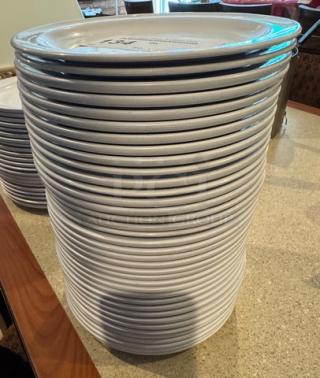 Stack of 37 G.E.T white ceramic plates, excellent condition, visible branding on top plate.