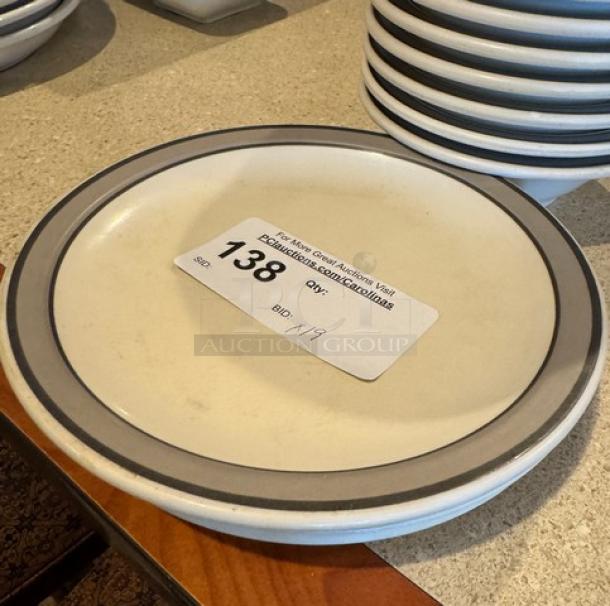 Set of decorative ceramic plates and bowls, light gray rim, excellent condition, auction label with lot number 138.