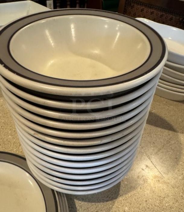Set of 14 decorative ceramic bowls and 14 plates, ivory with dark rim, in good condition. Ideal for dining or display.