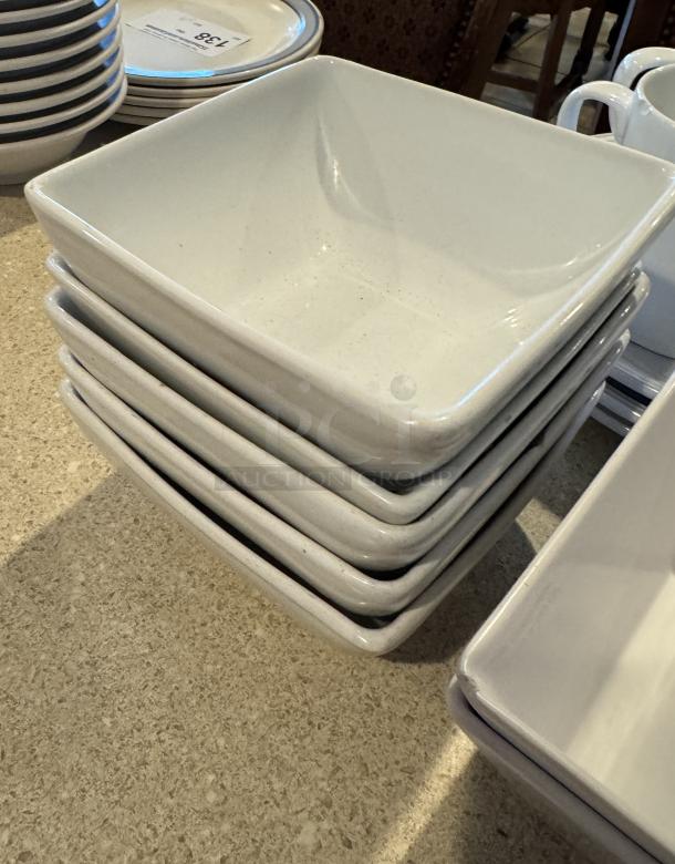 Assorted white ceramic deep bowls, plates, and cups, stacked neatly. Minimalist design, good condition, set of 14.