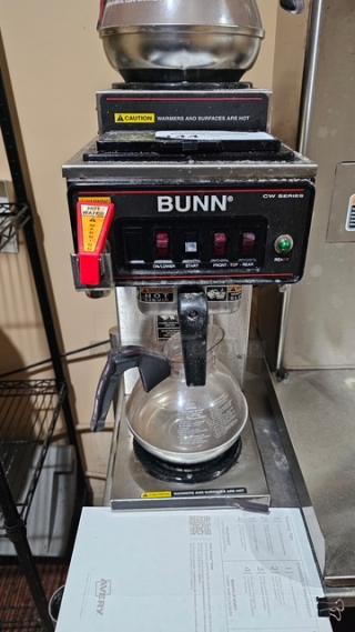 Bunn Coffee Maker with two top warmers and three pots. Model CW Series. Visible caution labels. Good condition.