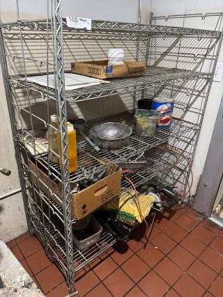 Metal wire floor rack with five shelves, used condition, containing various items. Label marked "105" on the top shelf.