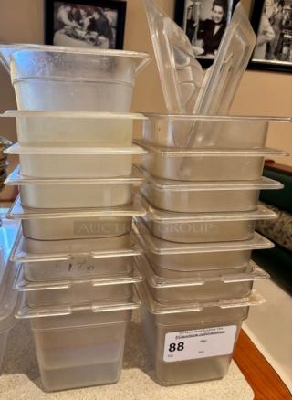 A stack of transparent plastic containers, 14 pieces. Some used, labeled with "Lot 88" for auction identification.
