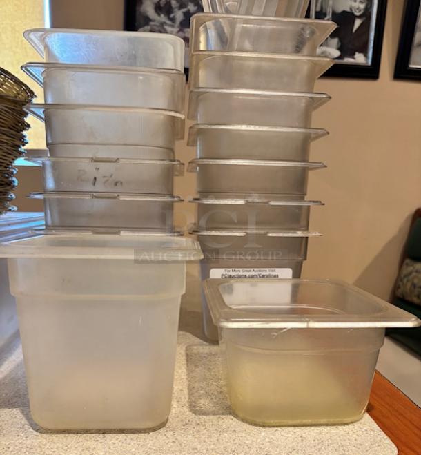 Stack of 14 plastic containers with lids, various conditions, ideal for storage. Slight discoloration visible.
