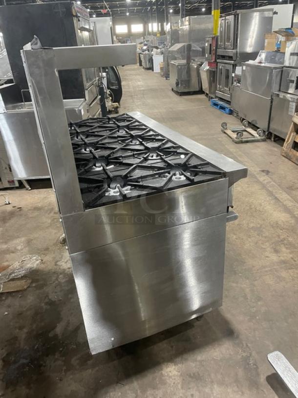 Garland H284 stainless steel 10-burner range with double oven, backsplash, and salamander shelf; natural gas, on legs.