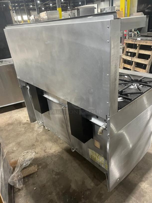 Garland H284 stainless steel 10-burner range with double oven, back splash, salamander shelf, and wired rack. Natural gas.