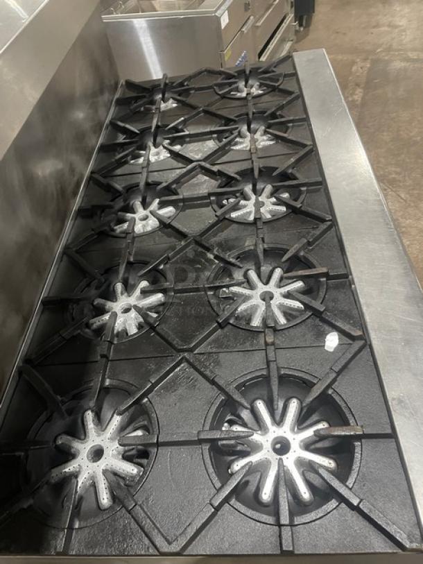 Garland H284 10-burner stainless steel gas range, double oven, backsplash, salamander shelf, wired rack, on legs.
