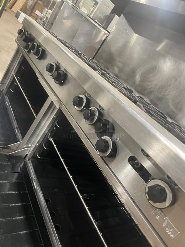 Garland H284 stainless steel 10-burner range with double oven, backsplash, overhead salamander shelf, and wired oven rack.
