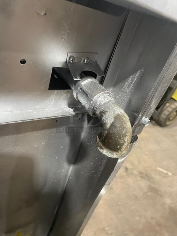 Close-up of gas connection for Garland stainless steel range, model H284; natural gas powered, industrial condition.