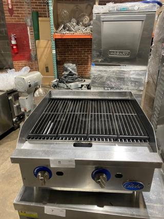 Globe stainless steel natural gas countertop charbroiler, model SN: 1715042736, on legs. Features adjustable knobs.