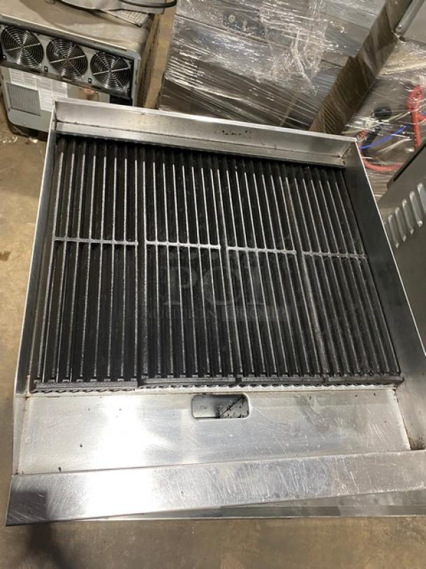 Globe stainless steel natural gas countertop char broiler, SN: 1715042736, on legs, features cast iron grates.