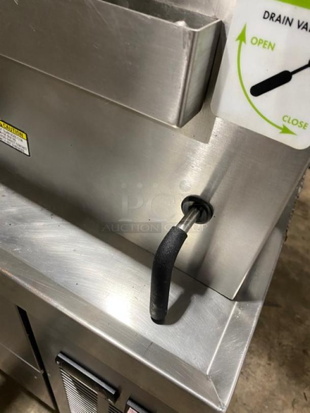 LoLo stainless steel single compartment countertop steamer with built-in pan rack, natural gas powered, drain valve open/close label.