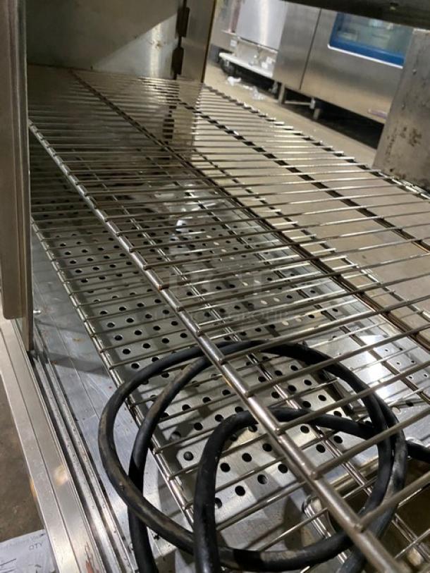 Commercial stainless steel countertop heated merchandiser display case with wired racks, on legs, electric powered.