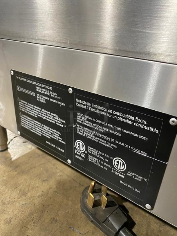 Commercial stainless steel electric griddle, Standard Range SREG24, 24", thermostatic controls, back & side splash, SN SR2370971, 208/240V, 1/3 phase, on legs, scratch-n-dent condition.