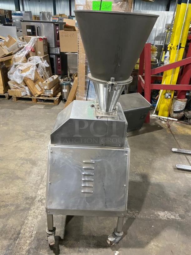 Commercial stainless steel electric sausage meat vacuum stuffer. Features heavy-duty construction, mounted on casters for mobility.