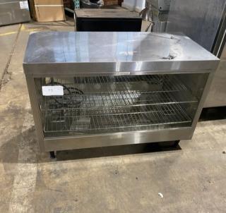 Carib Custom stainless steel electric countertop heated merchandiser display case, with wired racks and legs.