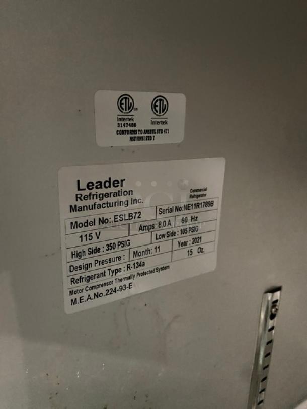 Leader Model ESLB72 3-door refrigerated lowboy cooler with backsplash, poly-coated racks, and casters. Serial NE11R1789B.