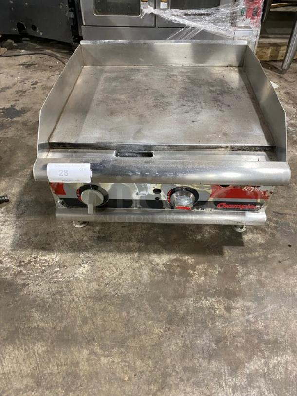 APW Wyott Champion Cook Series commercial stainless steel countertop flat griddle, natural gas, with back and side splash, on legs.