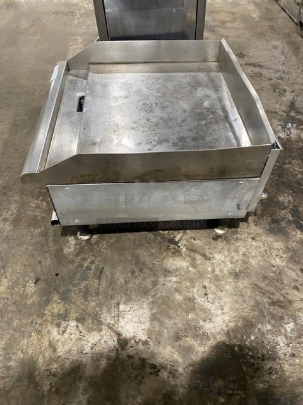 APW Wyott Champion Cook Series commercial stainless steel flat griddle with back and side splash, on legs; natural gas powered.