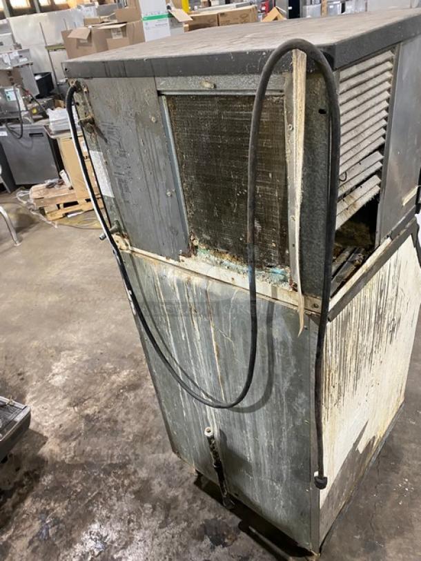 Manitowoc QY0454A ice machine, stainless steel, air-cooled, 115V, on legs, worn condition, working when removed.