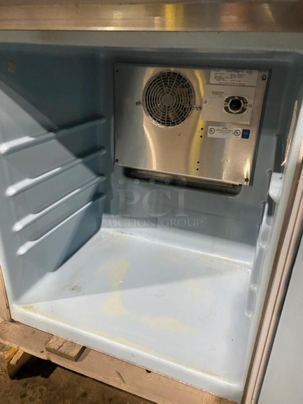 Delfield 406STAR2 stainless steel undercounter refrigerator interior, showing shelves, fan, and thermostat controls.
