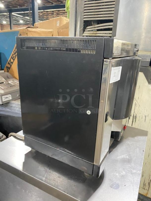 Italgi Cap-O-Mat Series stainless steel espresso machine, black, electric powered, automatic, on legs, 110V, visible wear.