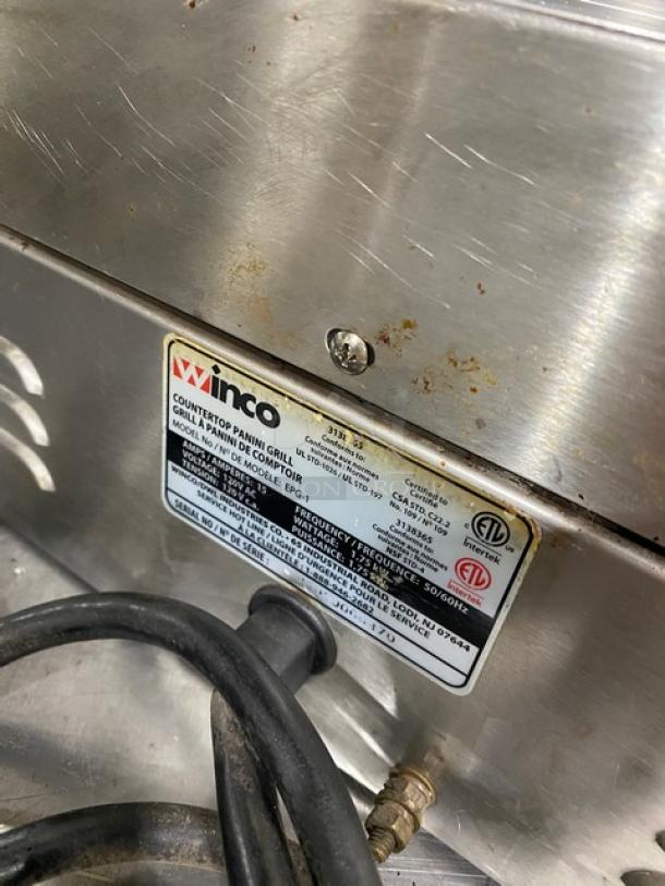 Winco EPG1 stainless steel electric panini grill with grooved grates, showing model label and power cord in used condition.