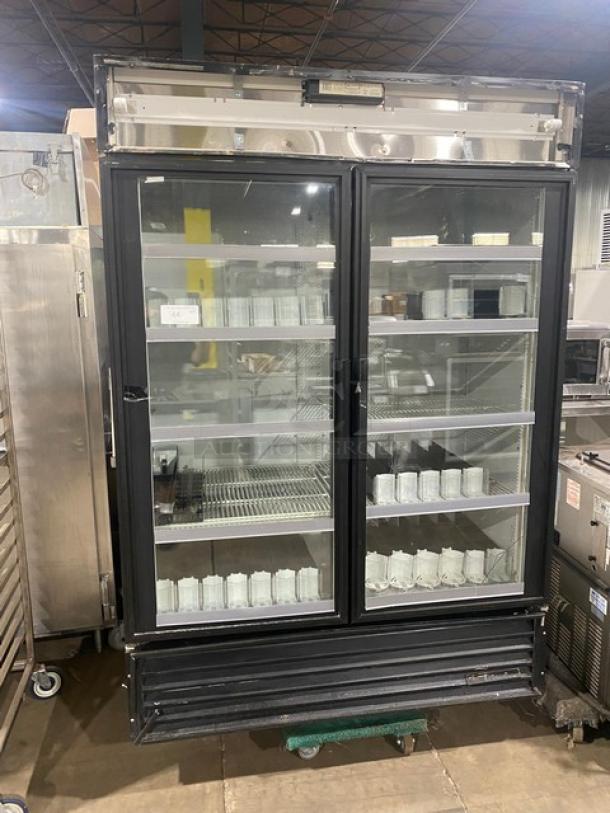 True commercial double glass swing door reach-in merchandiser refrigerator, model GDM-49, with poly-coated wire racks and beverage organizers.