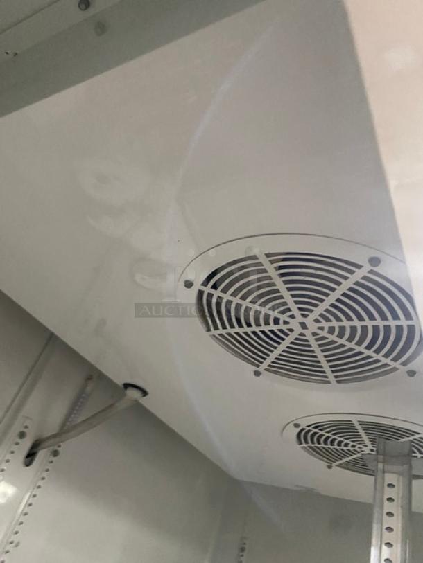 True commercial refrigerator interior with fan vents. Model: GDM-49. Features: poly-coated wire racks, beverage organizers.