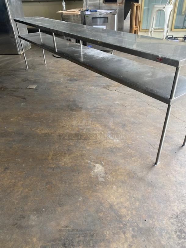 Heavy-duty stainless steel double overhead work shelf, 10 feet long, commercial-grade, excellent condition, durable construction.
