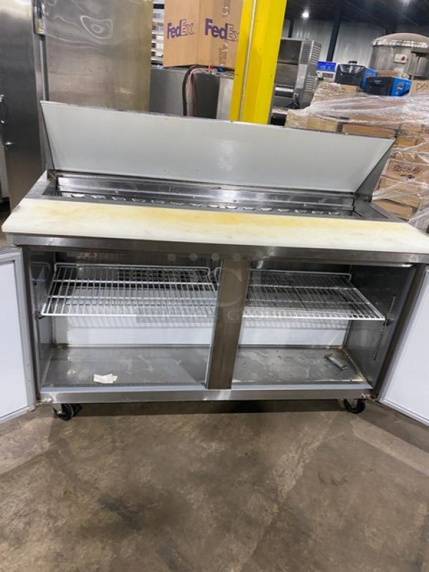 Avantco 60" stainless steel refrigerated prep table, model 178APT60HC, on casters, showing interior shelves and cutting board.