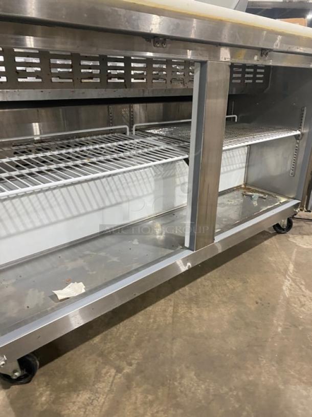 Avantco 60" stainless steel refrigerated prep table, Model 178APT60HC, on casters, features wire shelving and durable design.