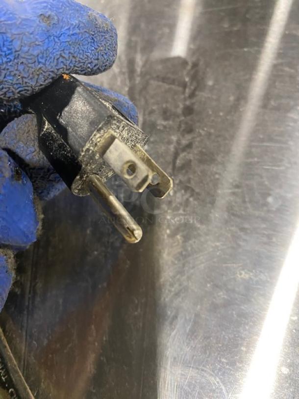 Close-up of a 115V power plug on the Avantco 178APT60HC refrigerated prep table.