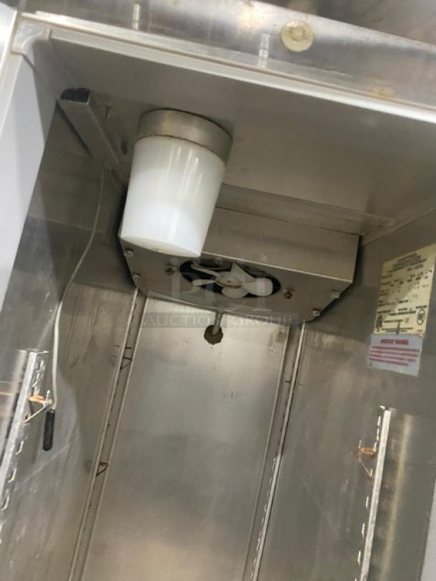 Continental Slim Series One Door Reach-In Freezer, Model DL1F6E, 115V, on casters, interior view with fan and labels.